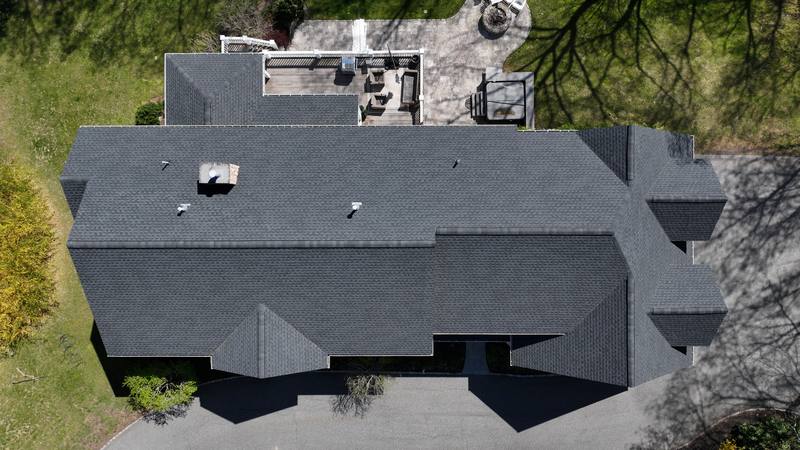 Dark shingle roof with a rooftop deck, top-down aerial